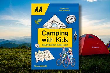 Camping with Kids guide against a background of tents in a field.