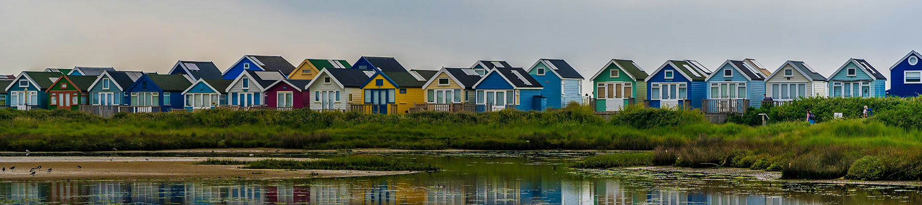 Colourful beach huts along the beach in Dorset.