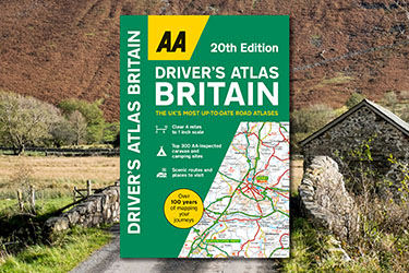 AA Driver's Atlas Britain against a background image of a country road and hills in the Lake District.