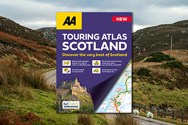 AA Touring Atlas Scotland against a background image of the Scottish countryside.