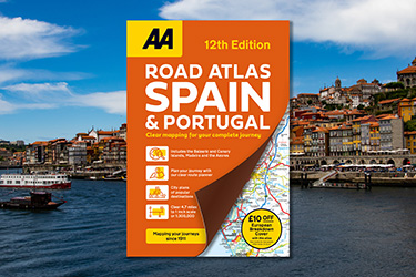 AA Road Atlas Spain & Portugal against a background image of a city against the ocean.