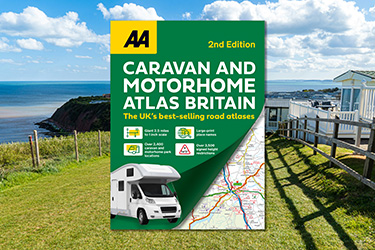 AA Caravan and Motorhome Atlas Britain against a background image of a caravan park overlooking a coastal cliff.