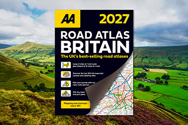 AA Road Atlas Britain against a background image of green fields and hills.